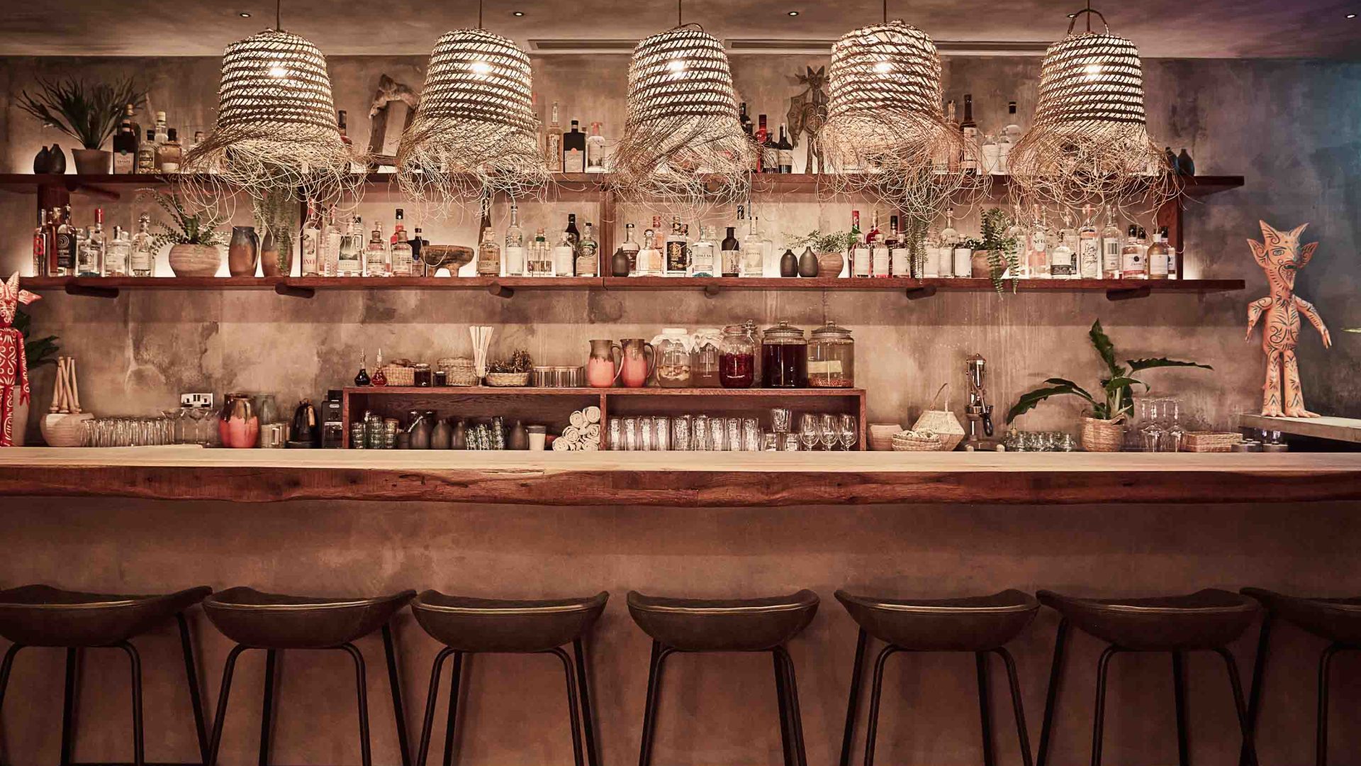 The interior of a bar, with stools and soft lighting.