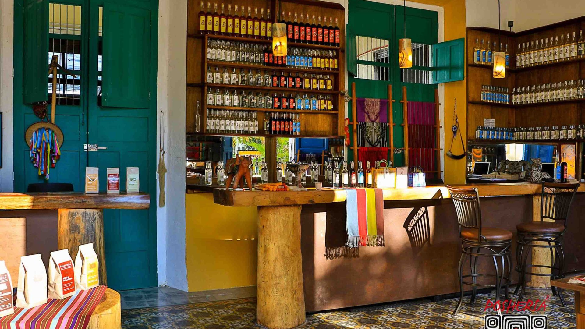 The interior of a bar with bottles, stools and a tiled floor.