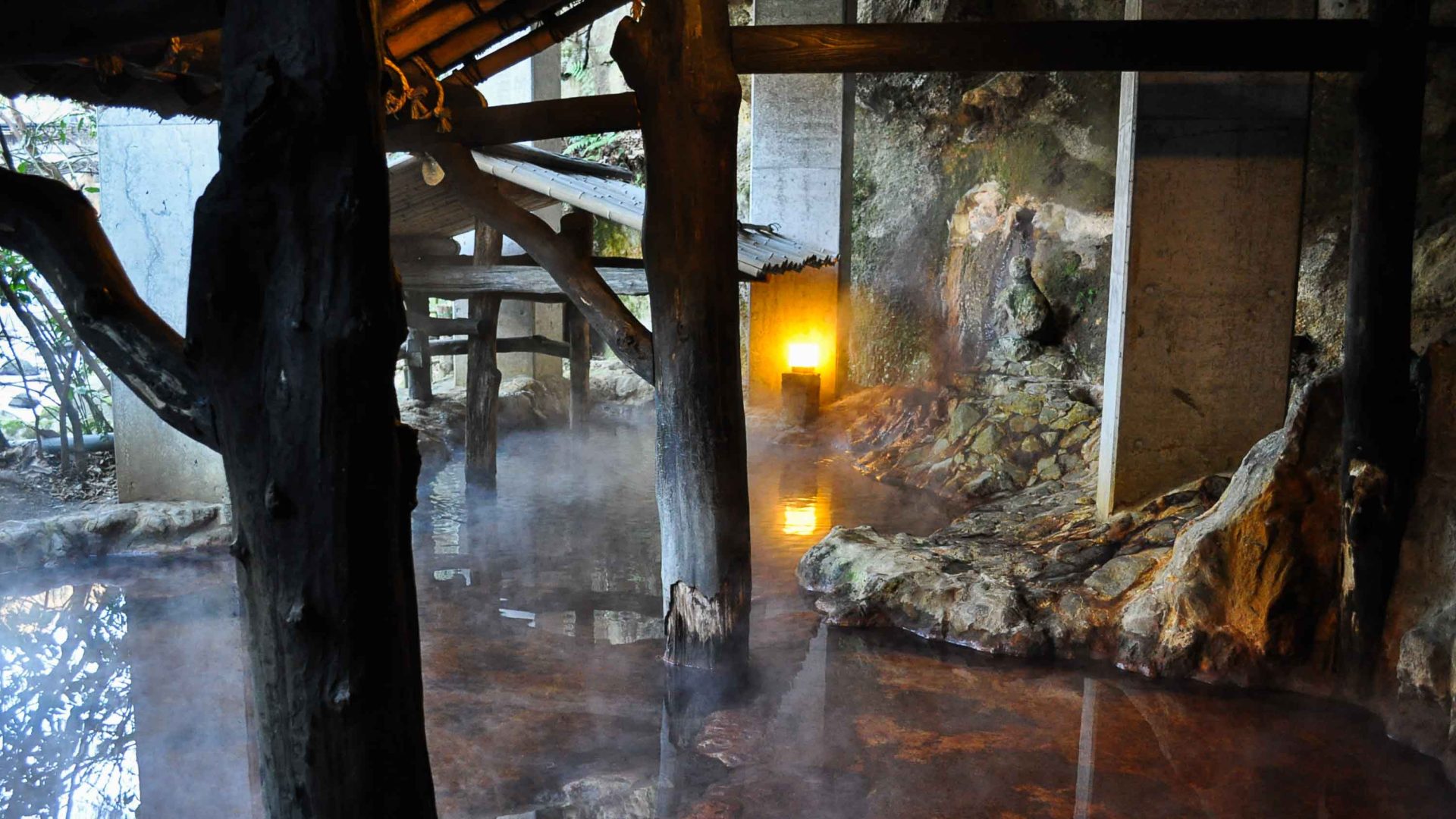 Steam rises from the water in a Japanese onsen.