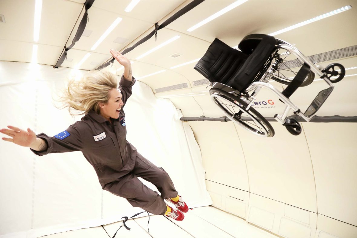 Sophie in zero gravity with her wheelchair also floating.