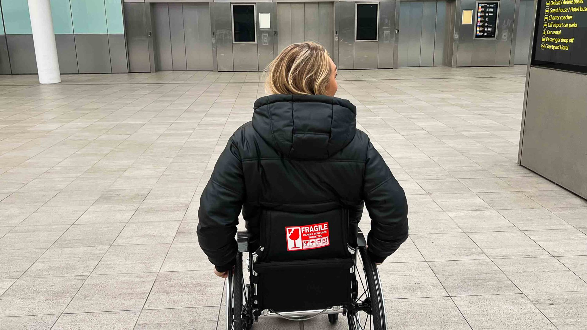 Sophie from the back is at an airport.