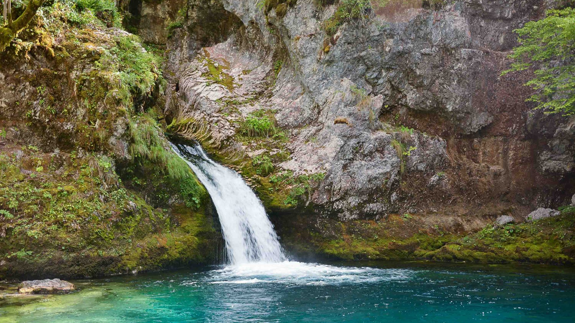 A lagoon with a waterfall running into it.