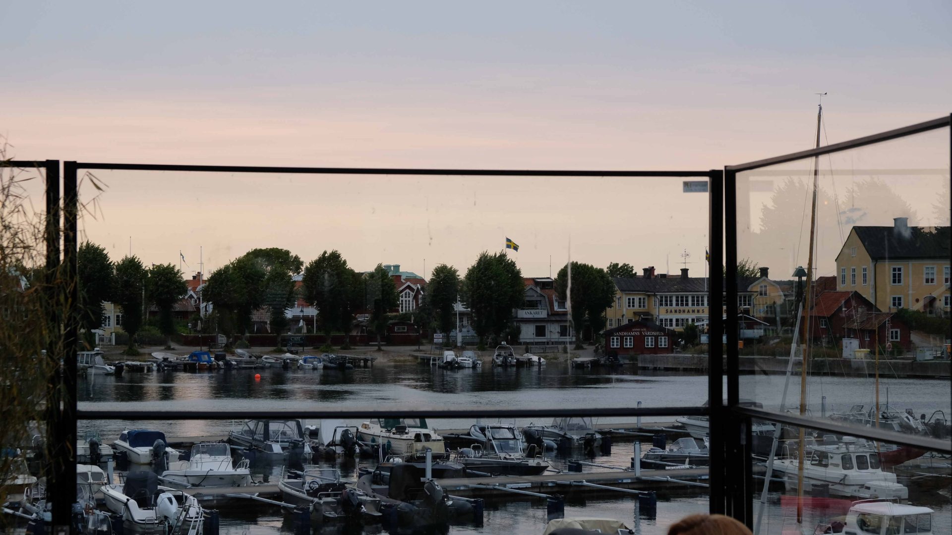 A view of boats in the Sandhamn harbor at dusk.