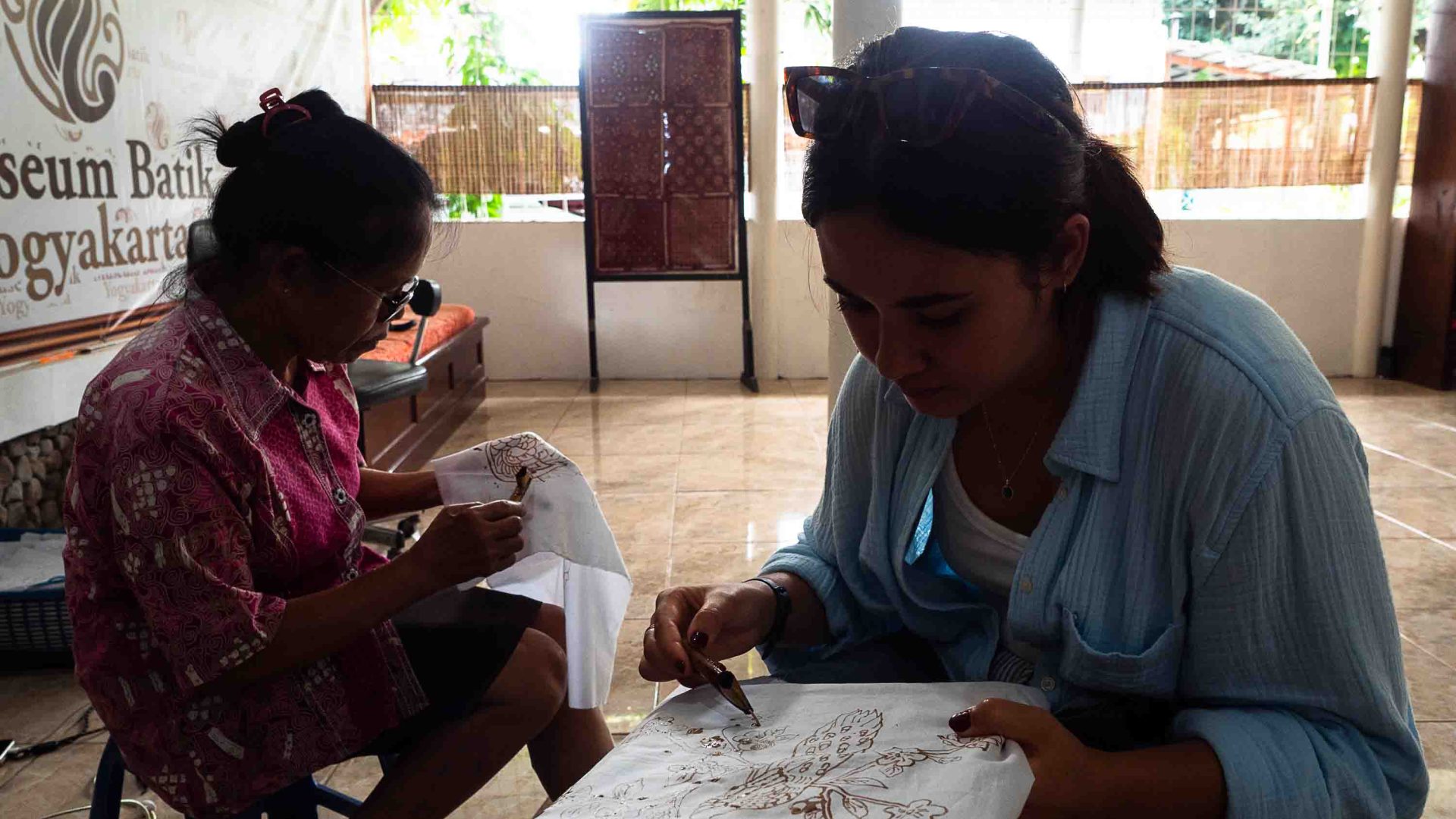 The writer learns the art of Batik with another woman.