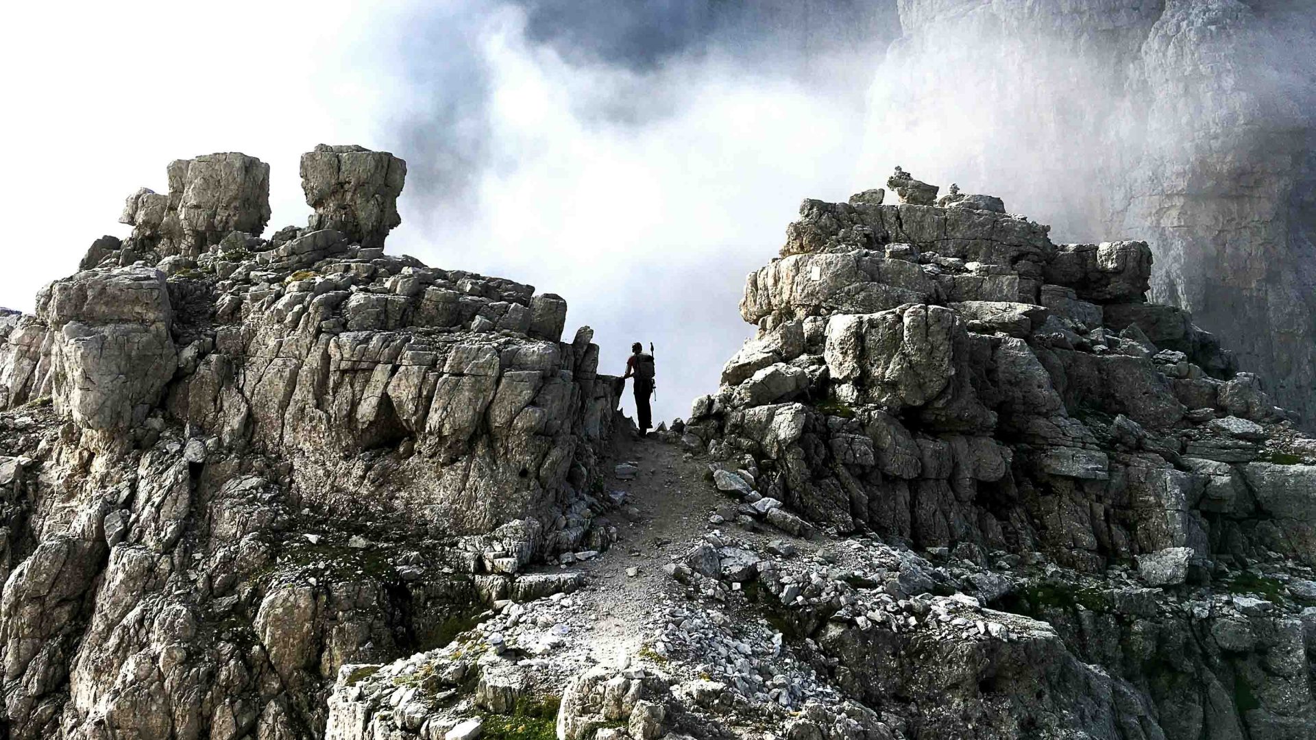 A person can be seen between two rocks.