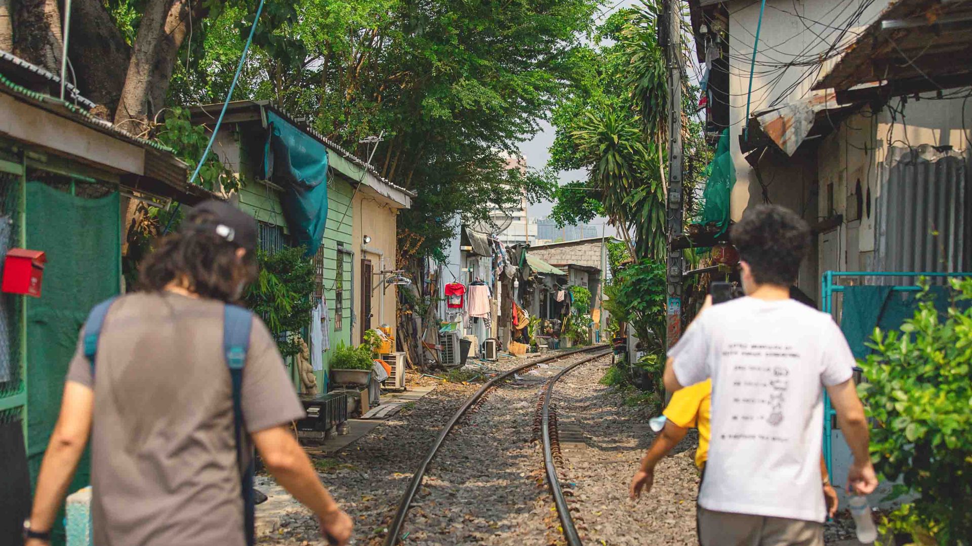 People walk through a small village on a Hear & Found sound recording trip.