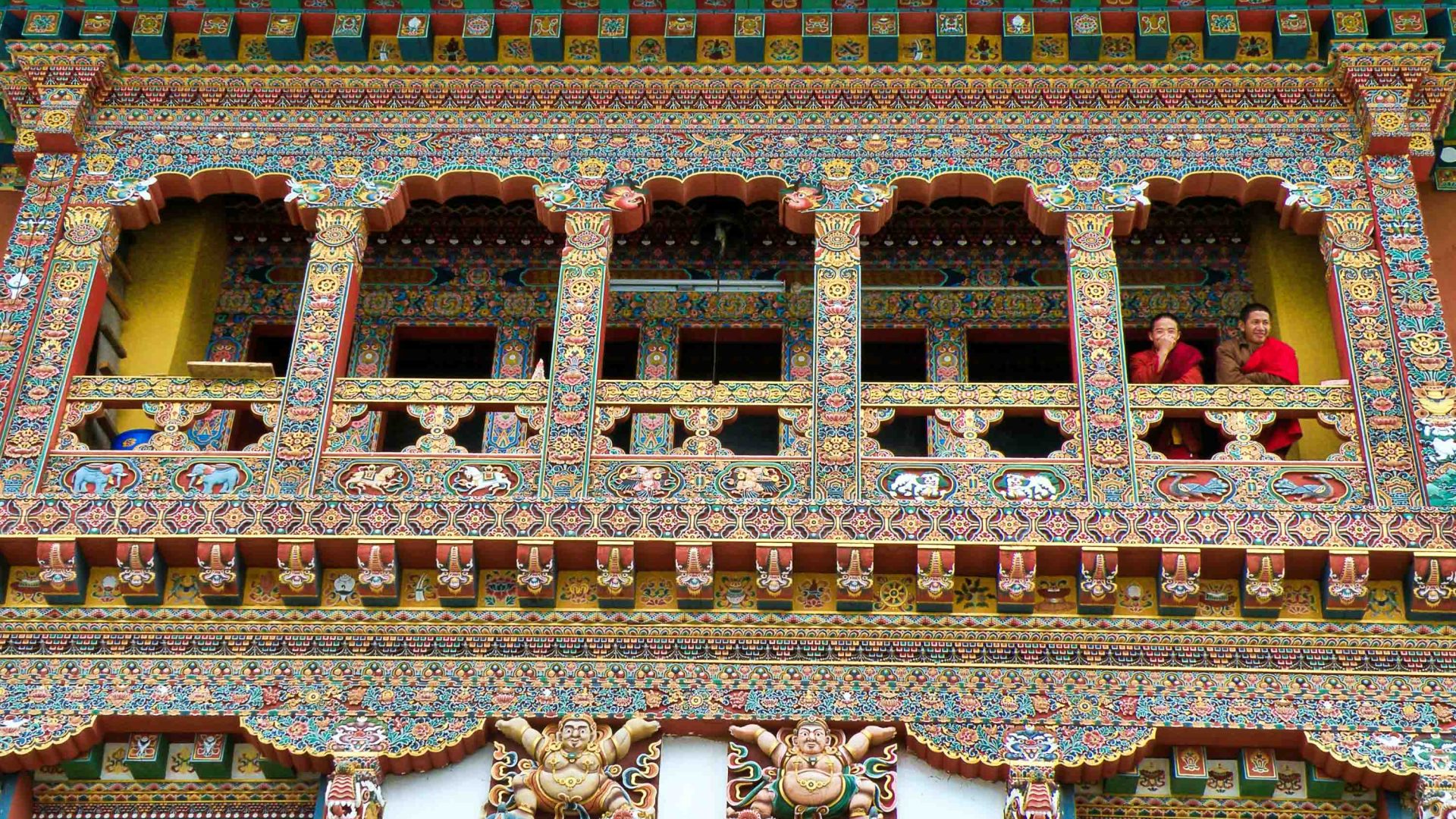 Two monks at the window of a temple.