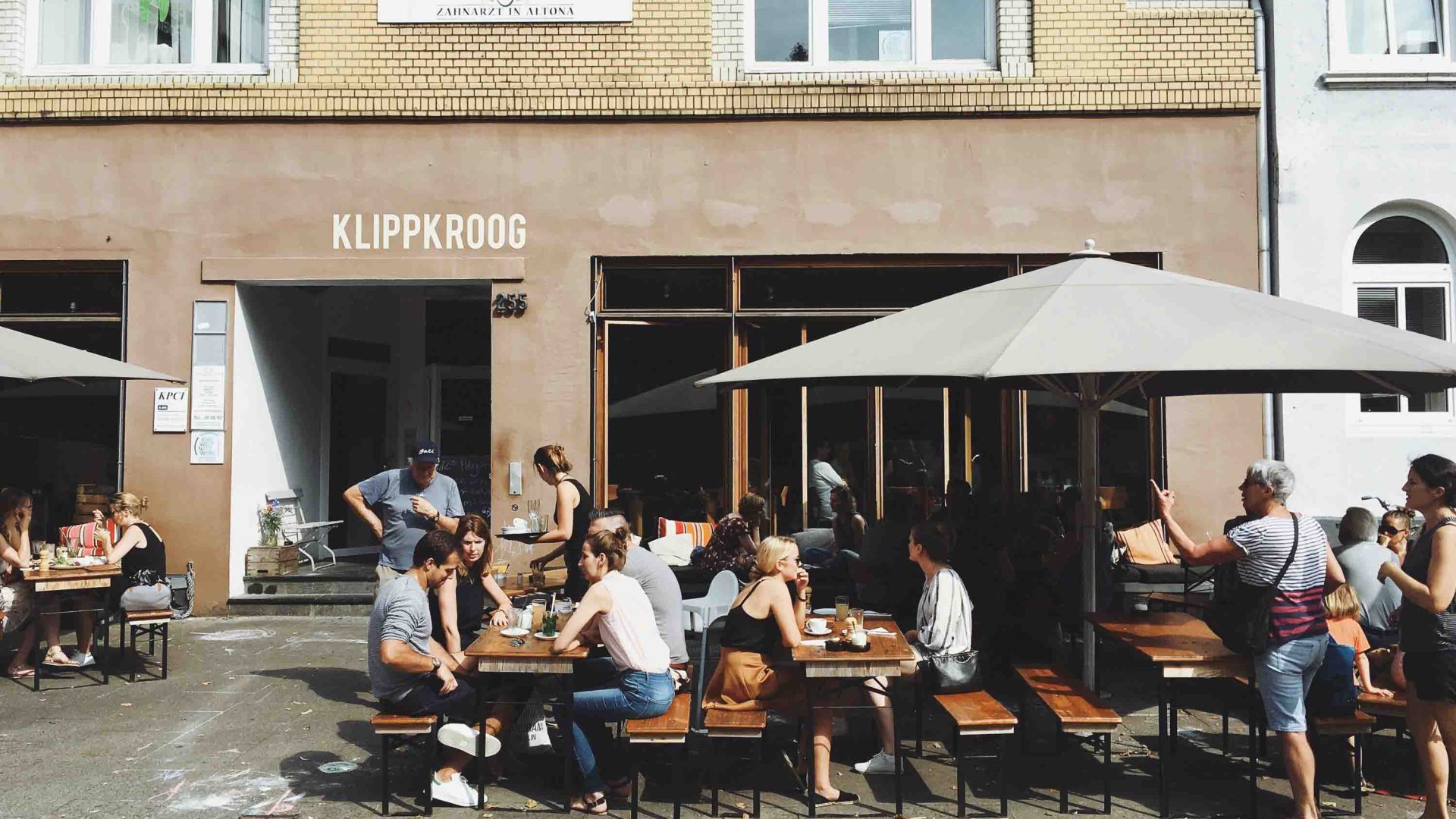 People enjoy outdoor dining at a cafe.