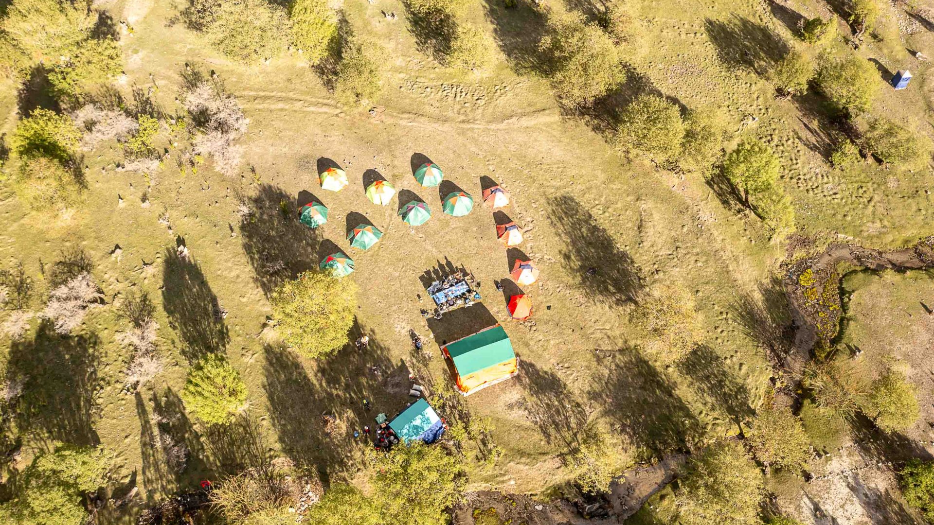 A drone shot of tents and a table set up in the valley.