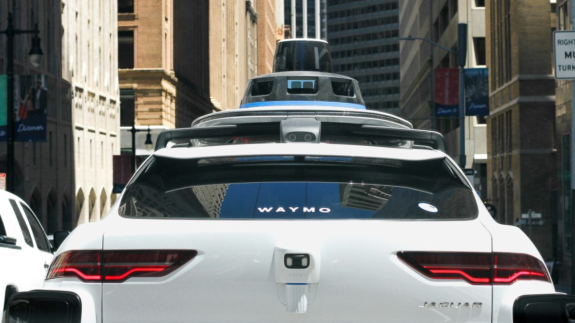 A waymo taxi in the street.