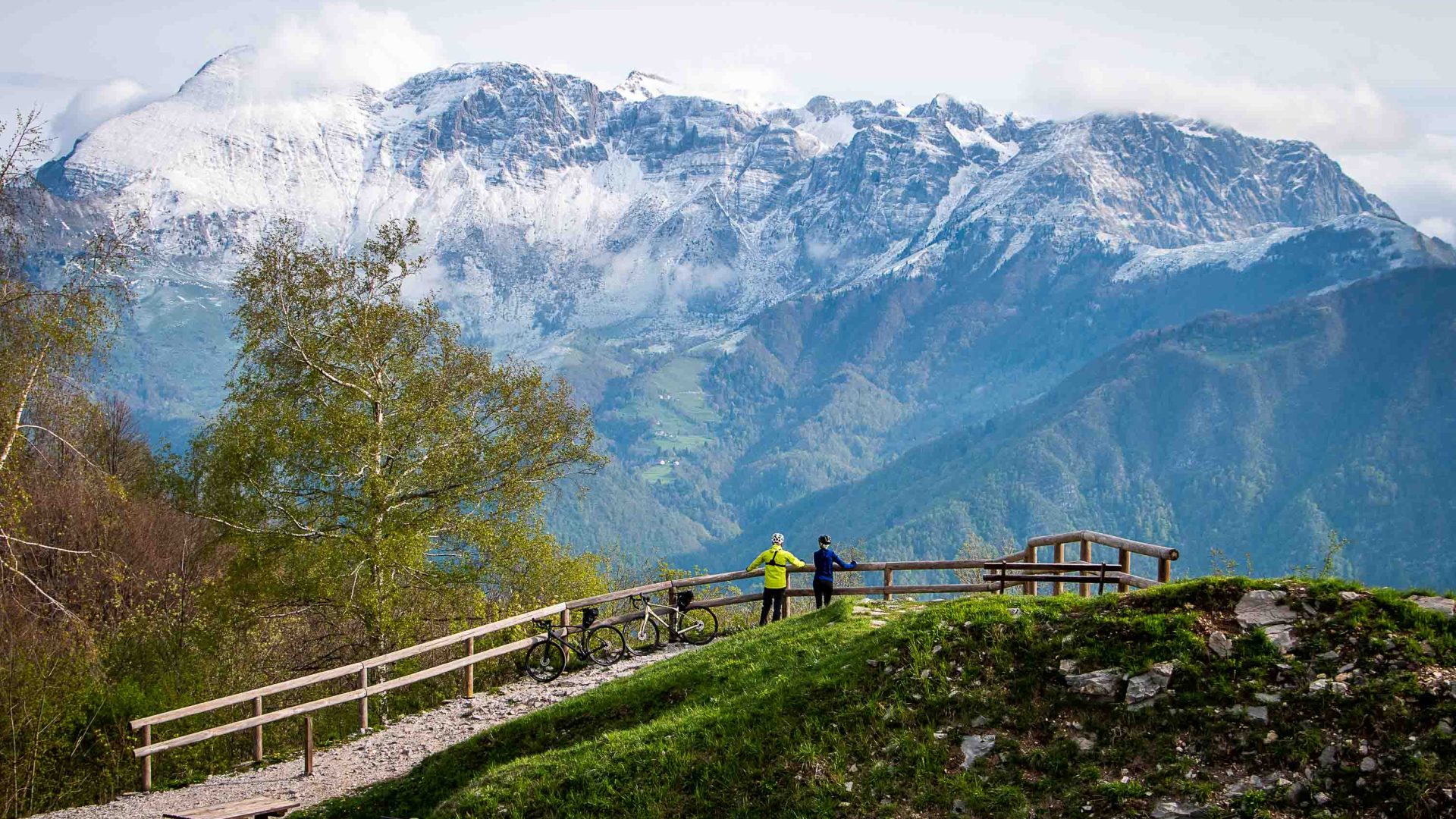 Cyclists enjoy the mountain vistas from a look out.