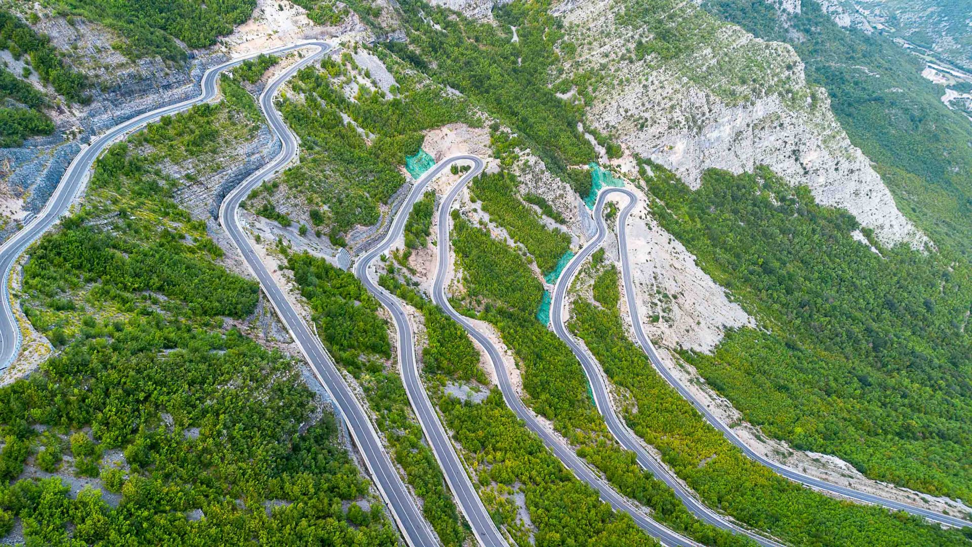 Roads zig zag down a mountain.