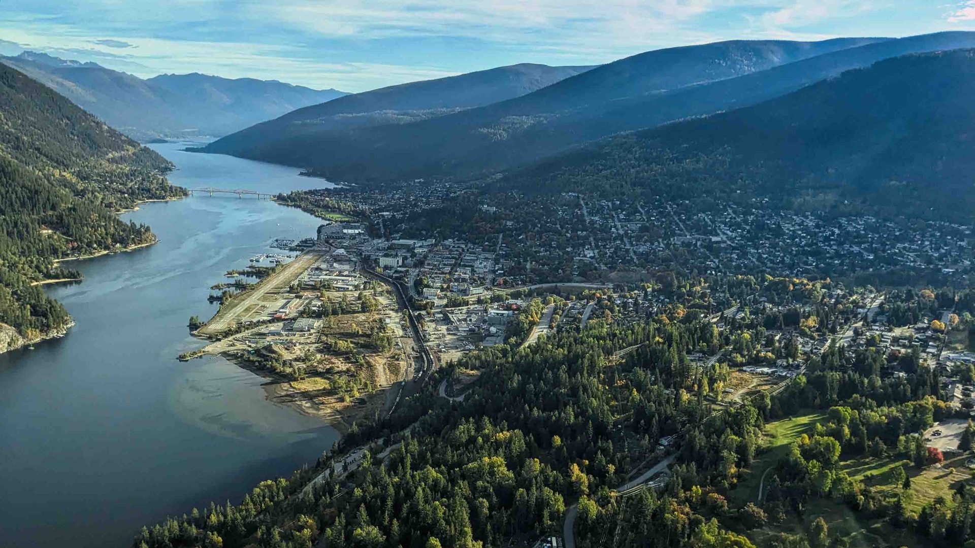 An aerial view over a lake and town.