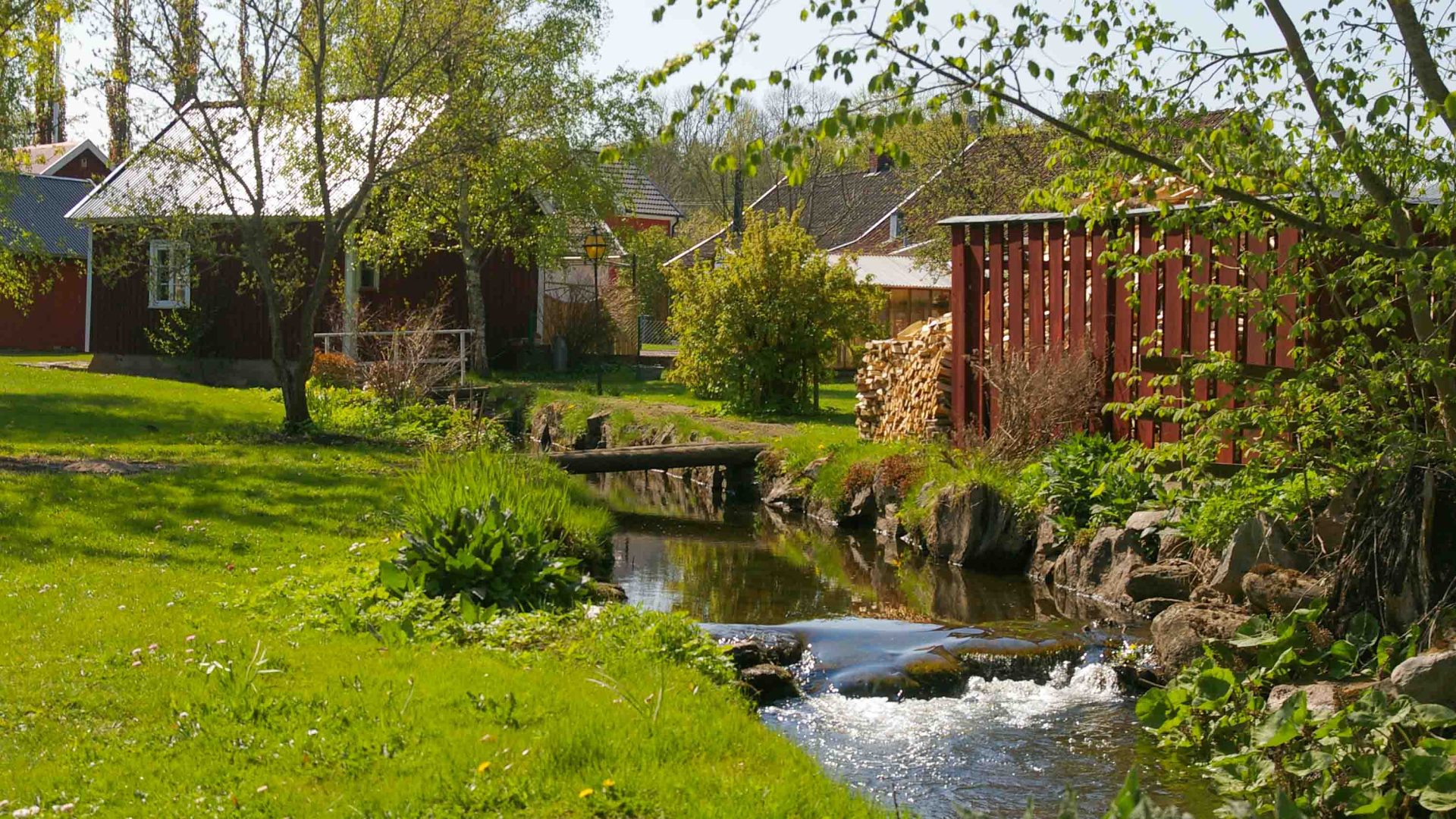 A house with a stream in its garden.