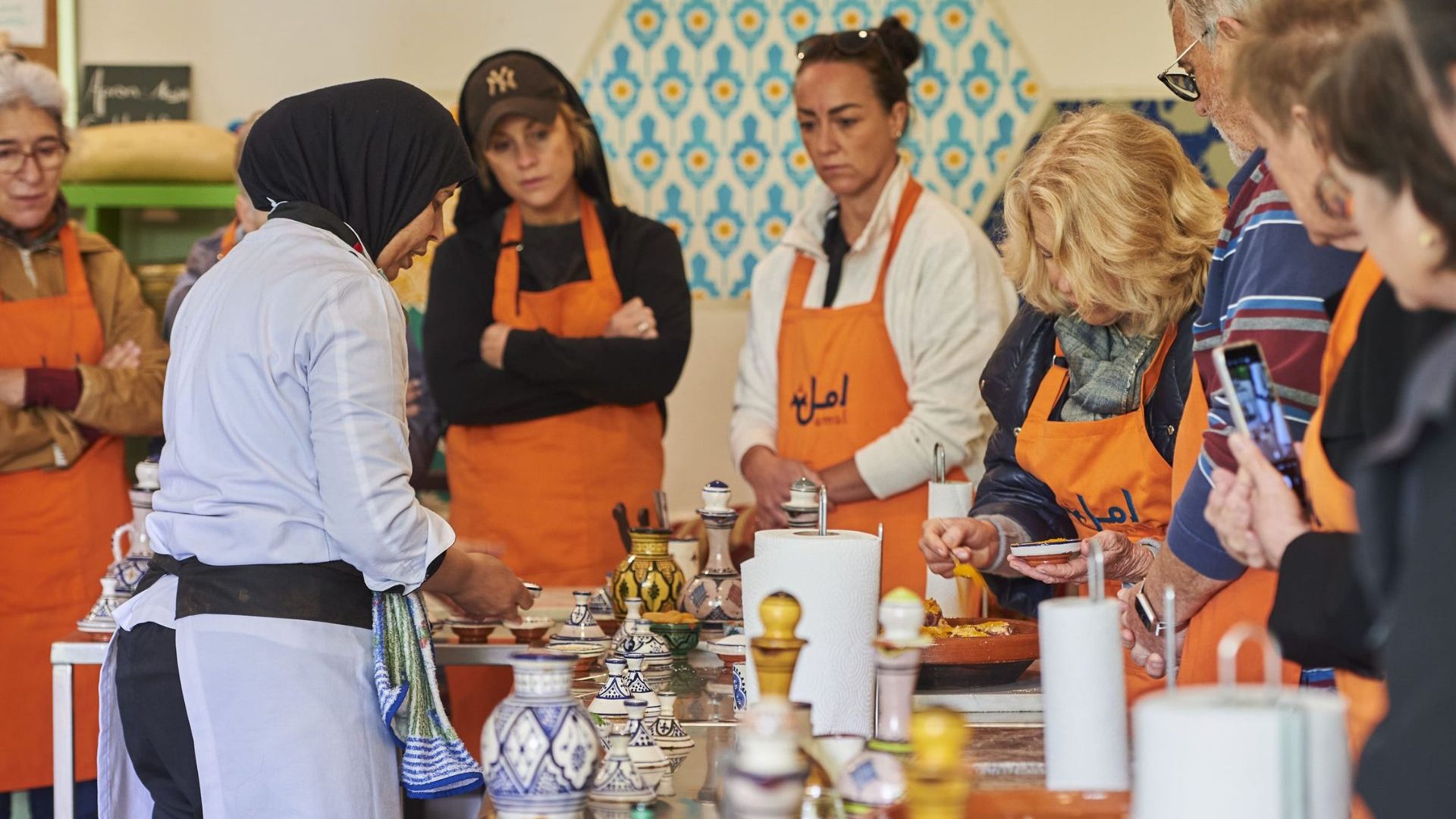 An Amal cook leads a group cooking class