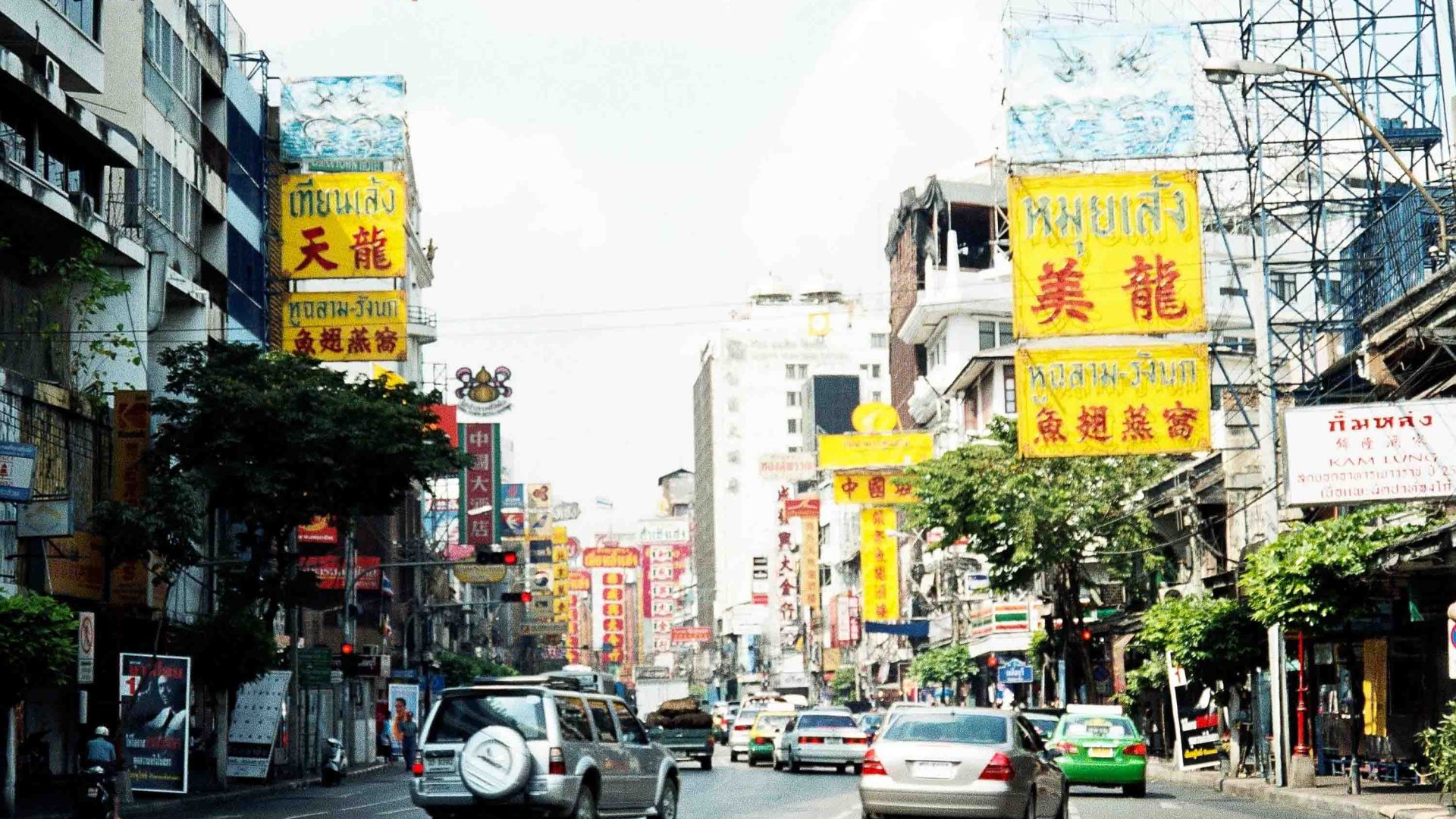A sroad with lots of buildings with Chinese characters on them.