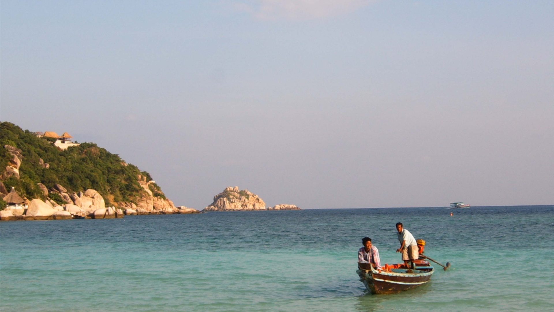 A row boat in calm blue water.