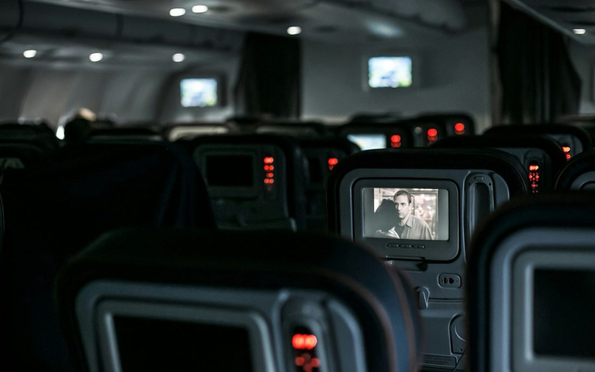 Rows of seatback TVs during a night flight