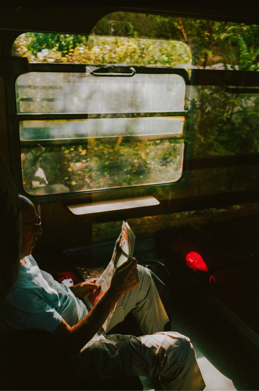 man reads book on train