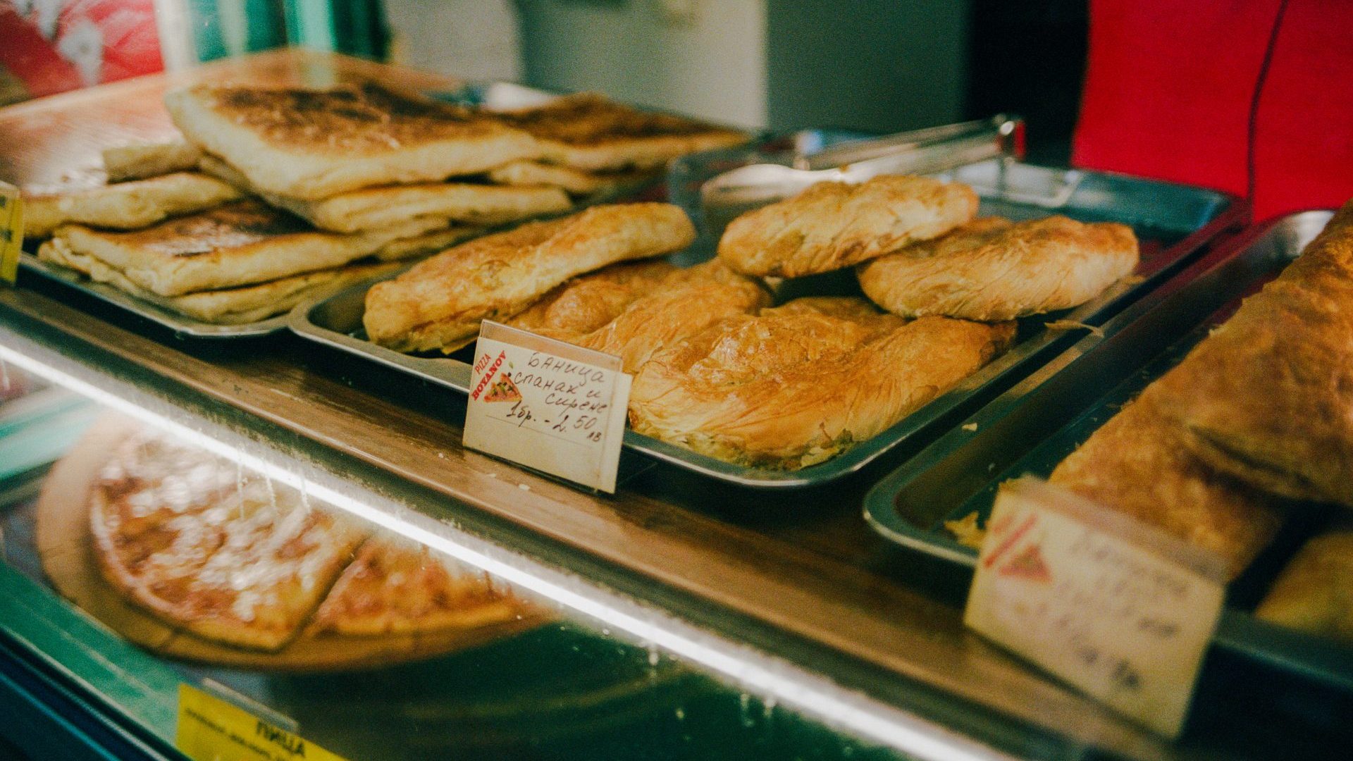 Ordering a classic Bulgarian banitsa, aflaky pastry stacked with eggs, feta and yogurt, from HleBar Bakery.