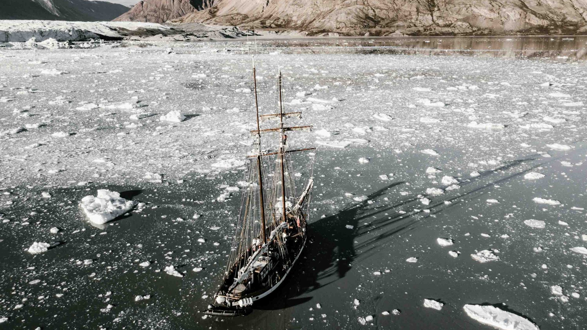 A boat ploughs through the ice in Greenland's waters.