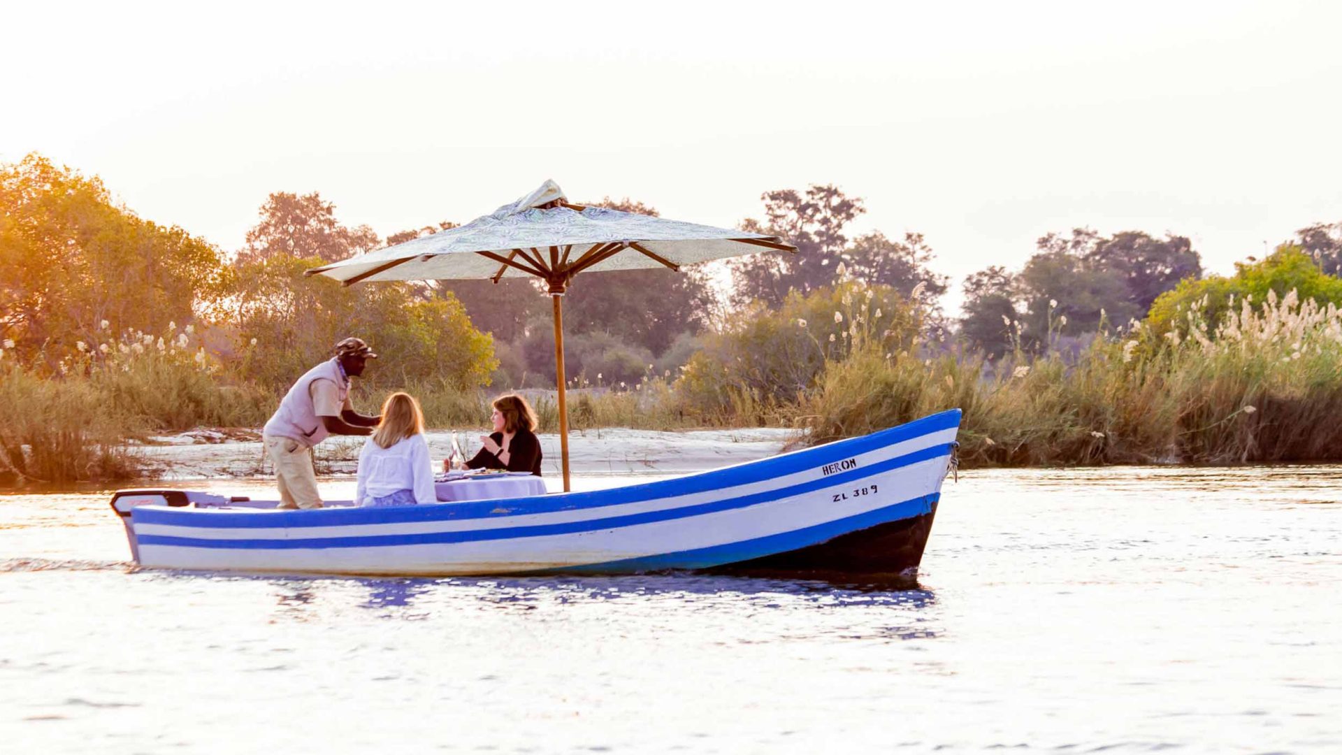 A electric dhow on a river.