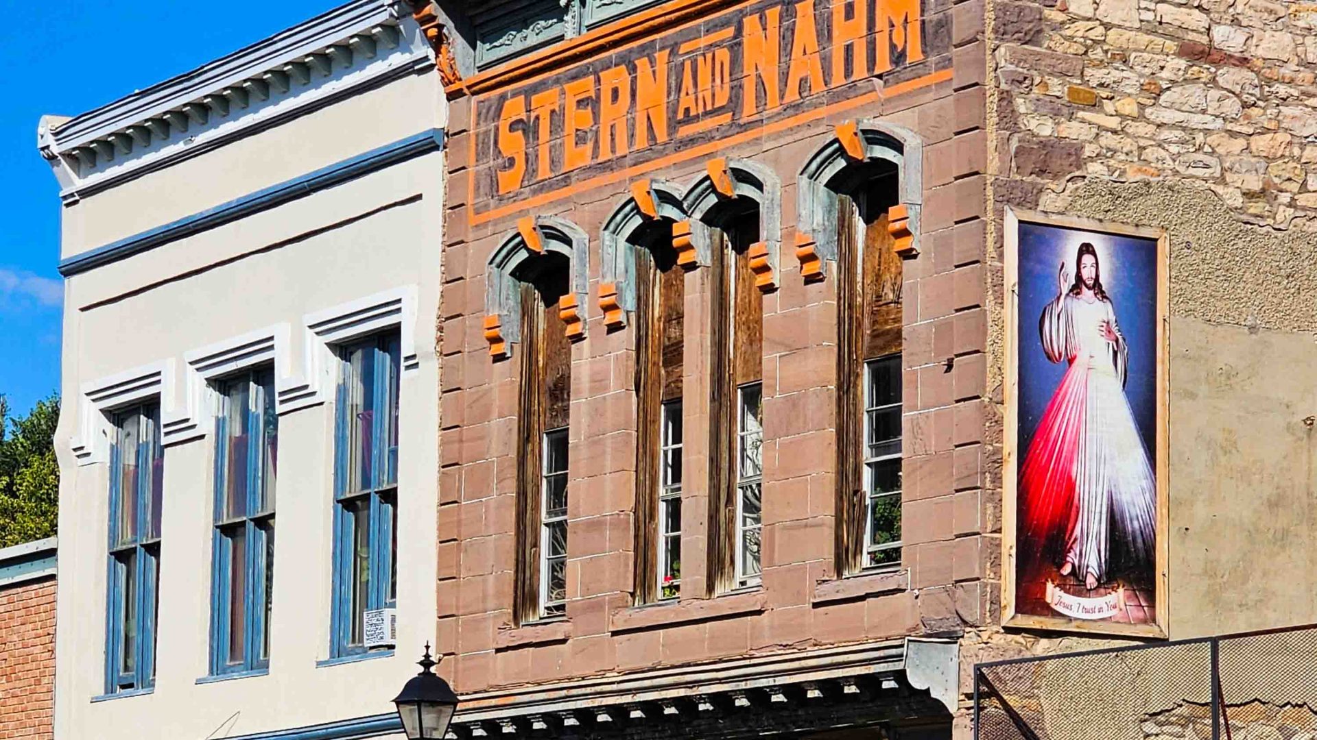 An old brick building with a painted mural on one wall.