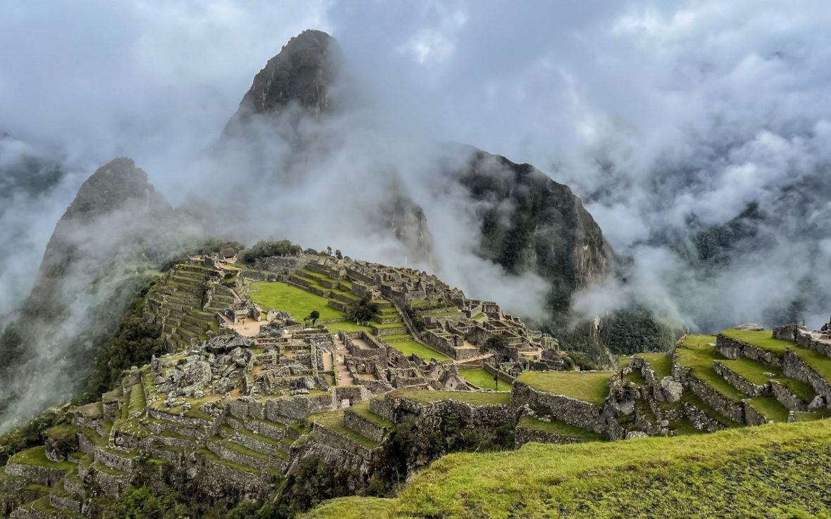 A scene of Machu Picchu with rising clouds in the foreground