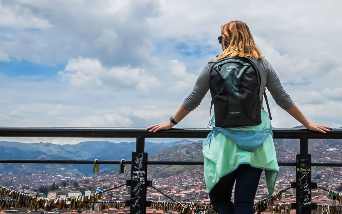 A woman on a terrace looking out over the city from a height