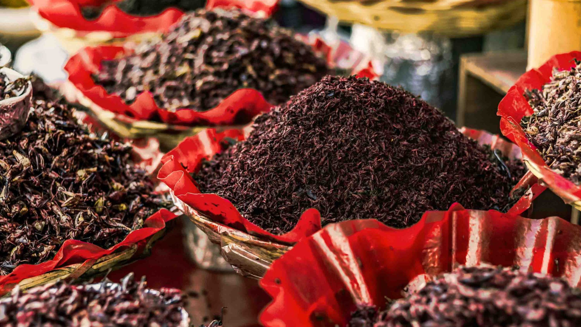 Dishes of deep-fried chapulins (grasshoppers) at a market.