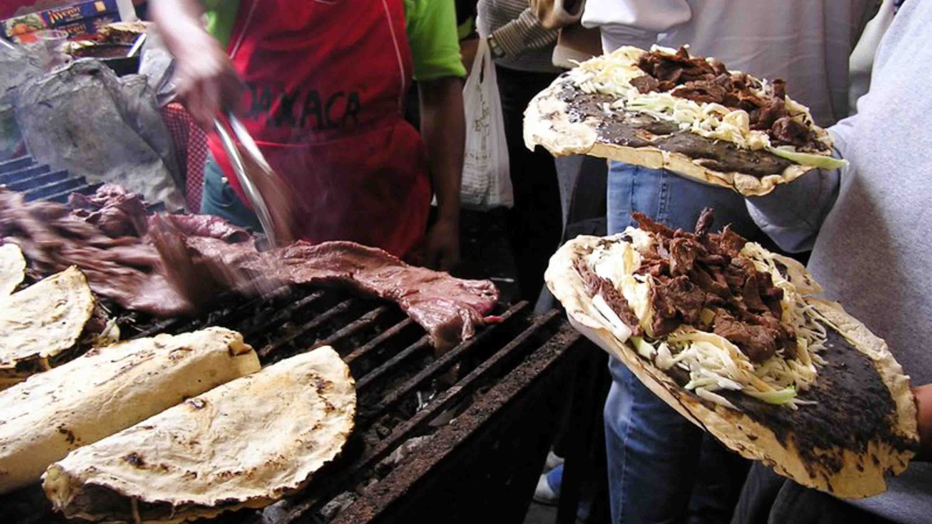 Tlayudas being prepared over a stove.