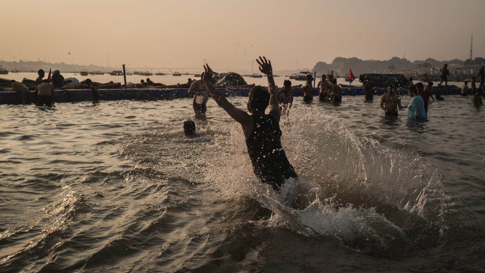 Devotees swim in the purifying waters