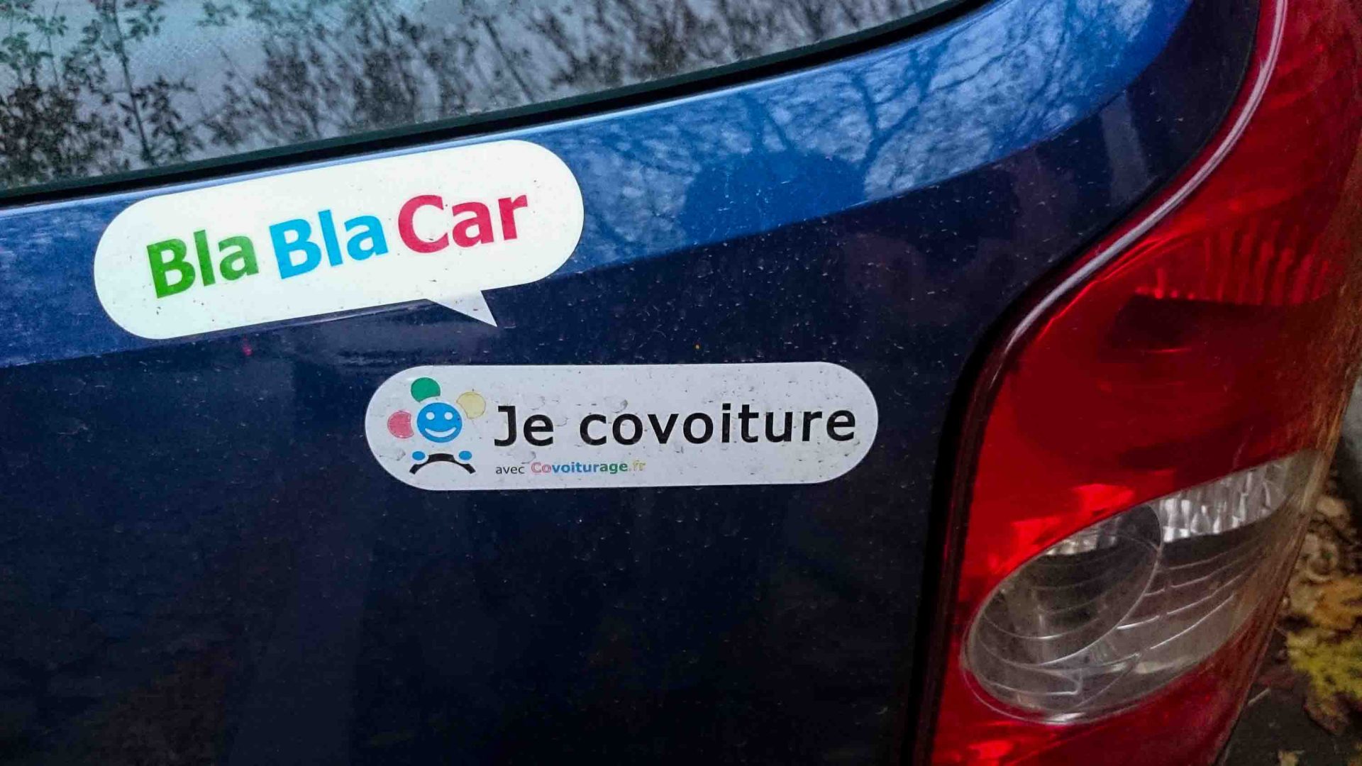 The back of a car with the stickers for BlaBlaCar on it.