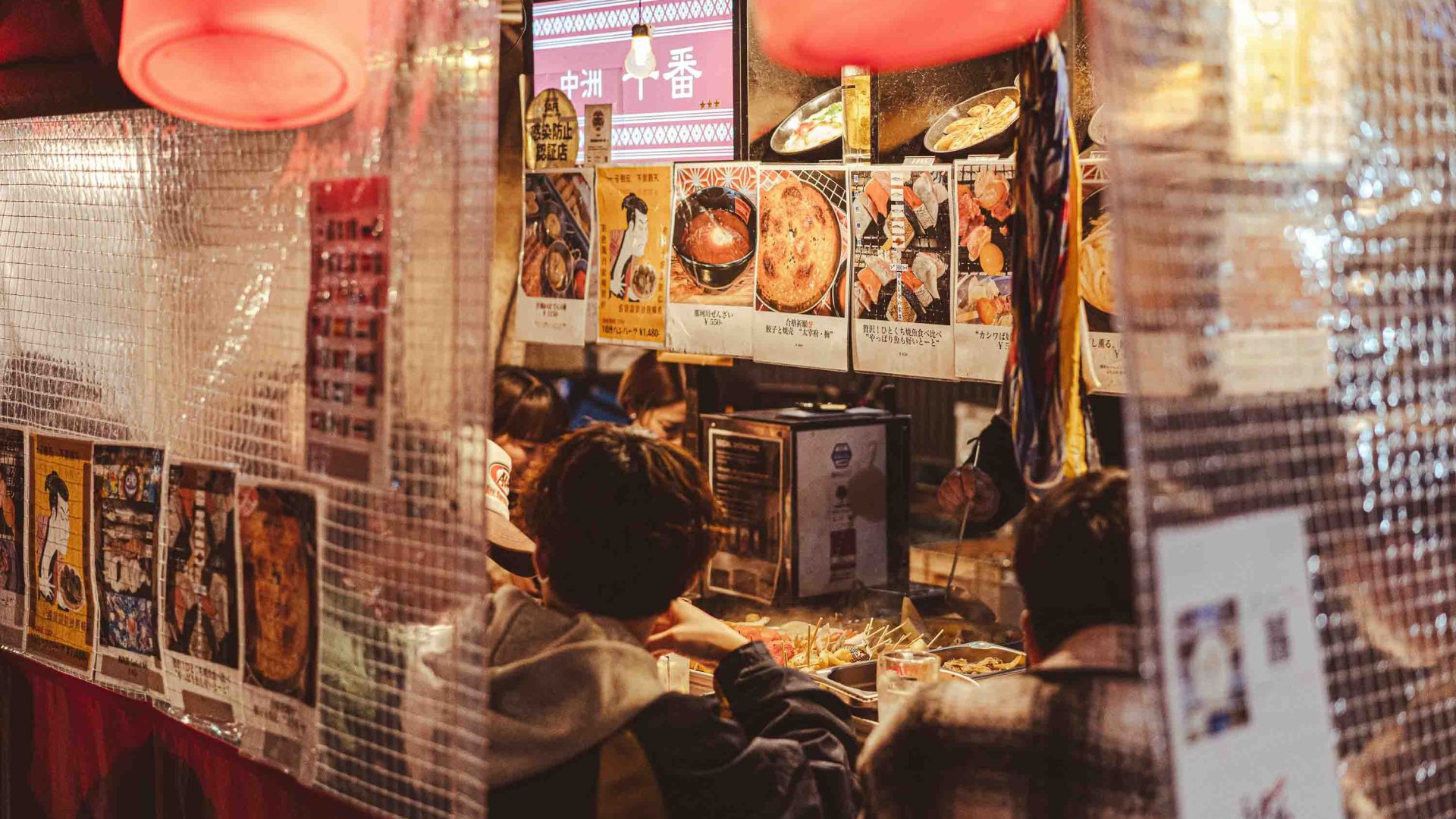 People eat at a yatai.