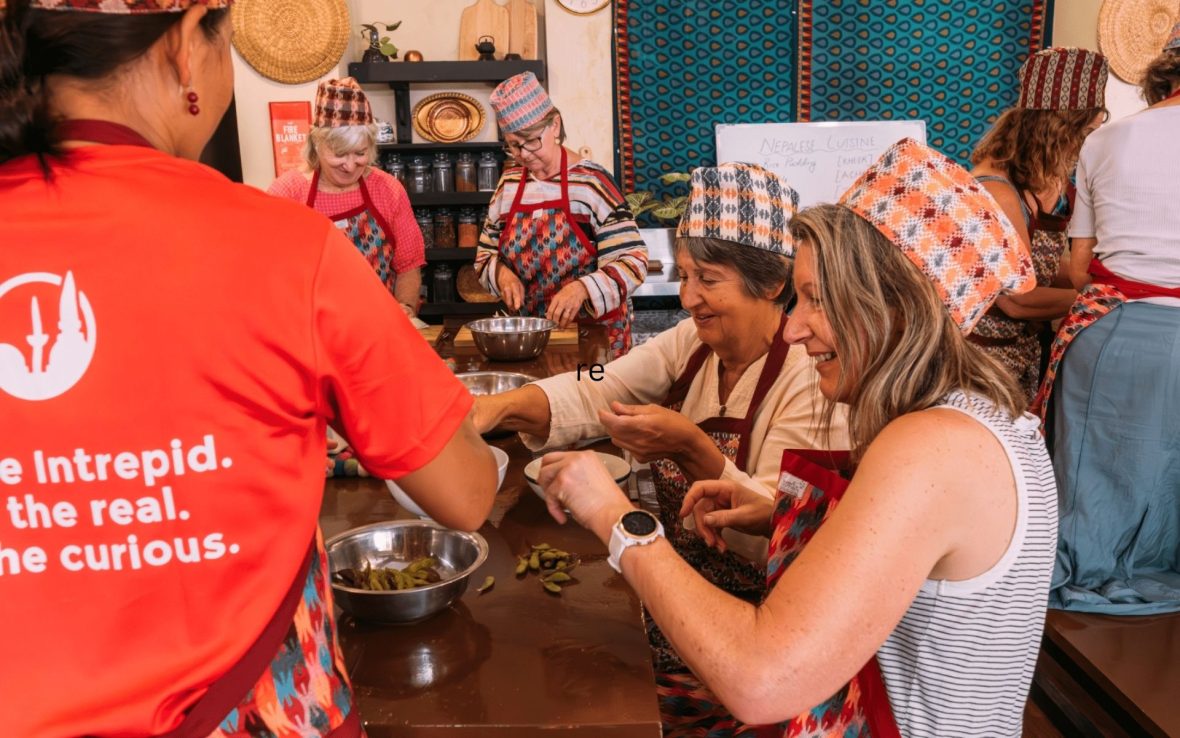 A group of travelers preparing local dishes during a cooking lesson.