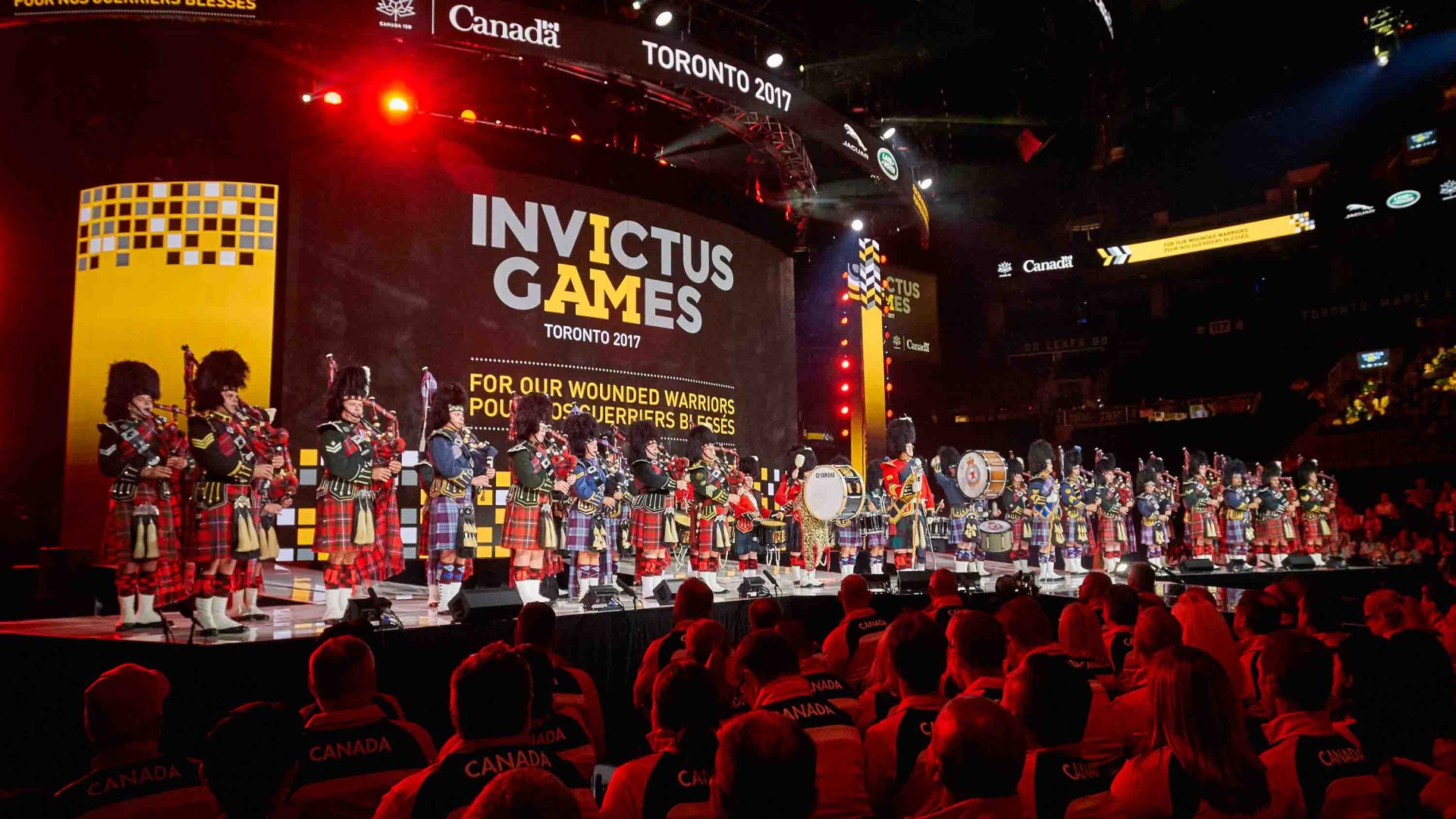 A stage with performers and a background that reads 'Invictus Games'.