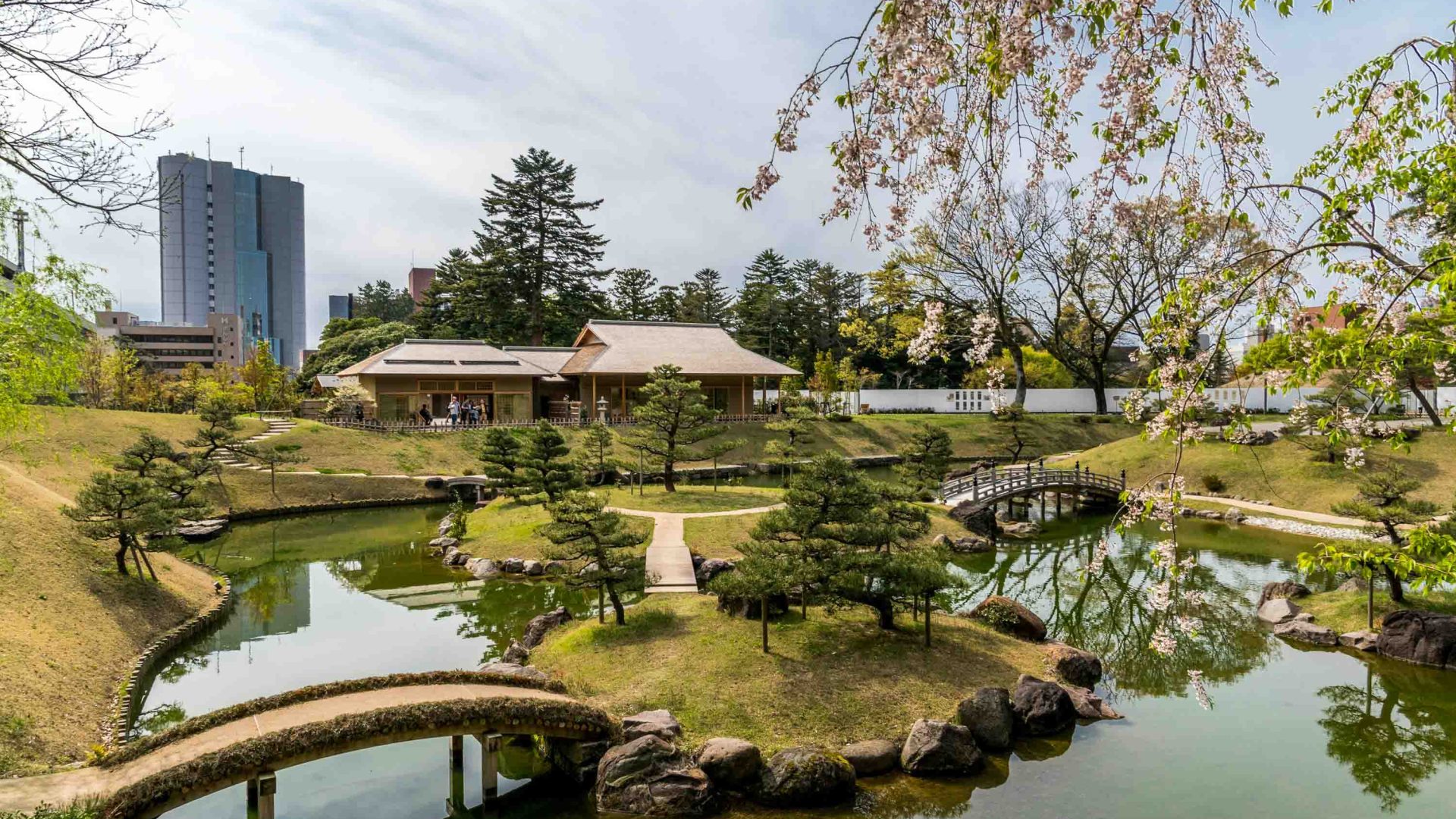 A temple in amongst ponds and landscaped gardens.