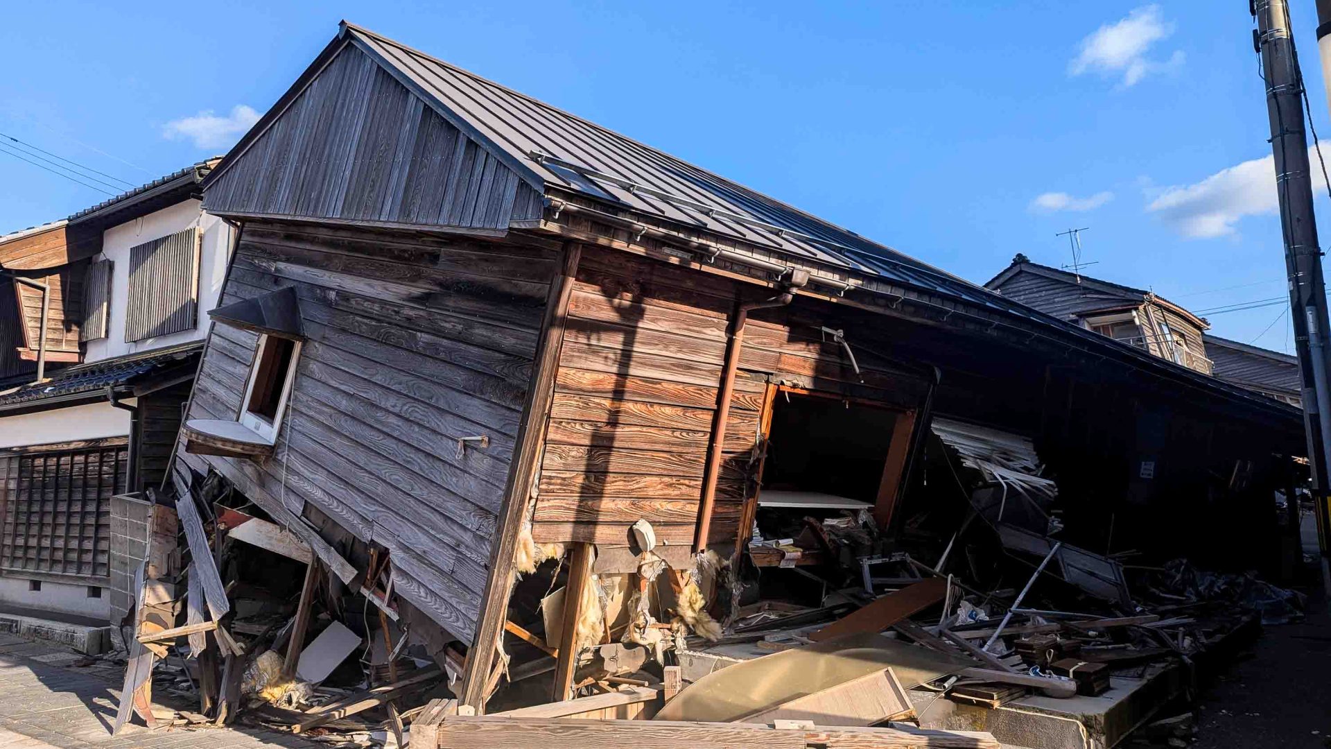 A partially collapsed wooden building.