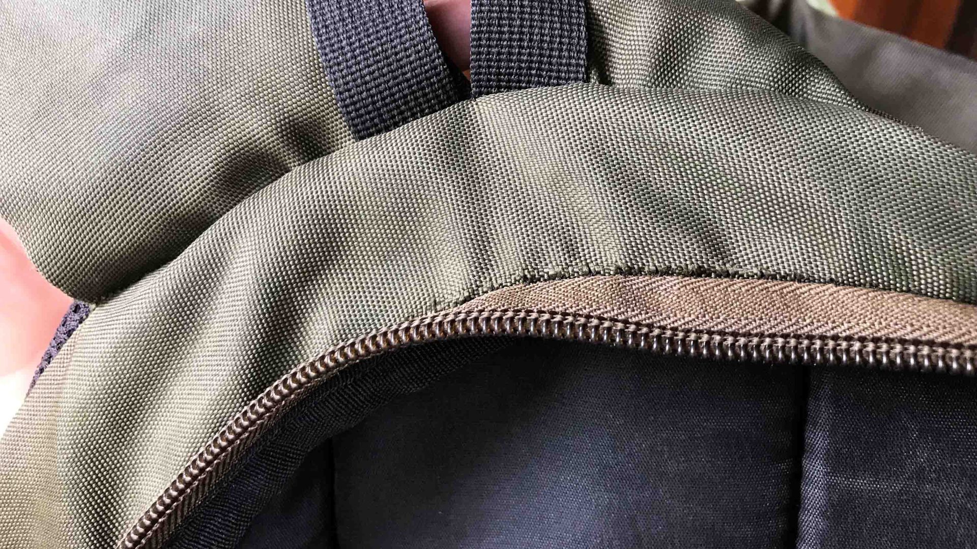 A backpack with repairs made to a seam.