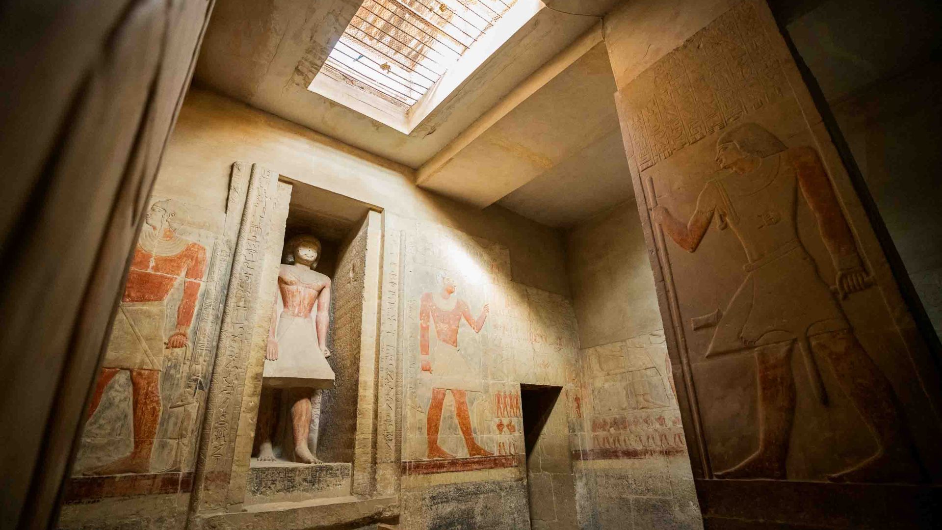 Light comes down upon the interior of a room in Saqqara, lighting up the hieroglyphics.