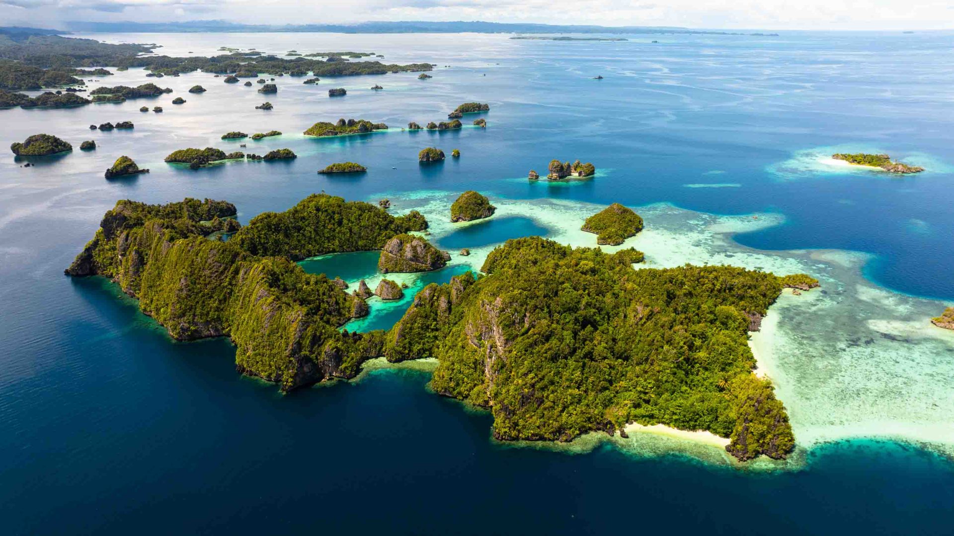 A cluster of islands in blue and green water.