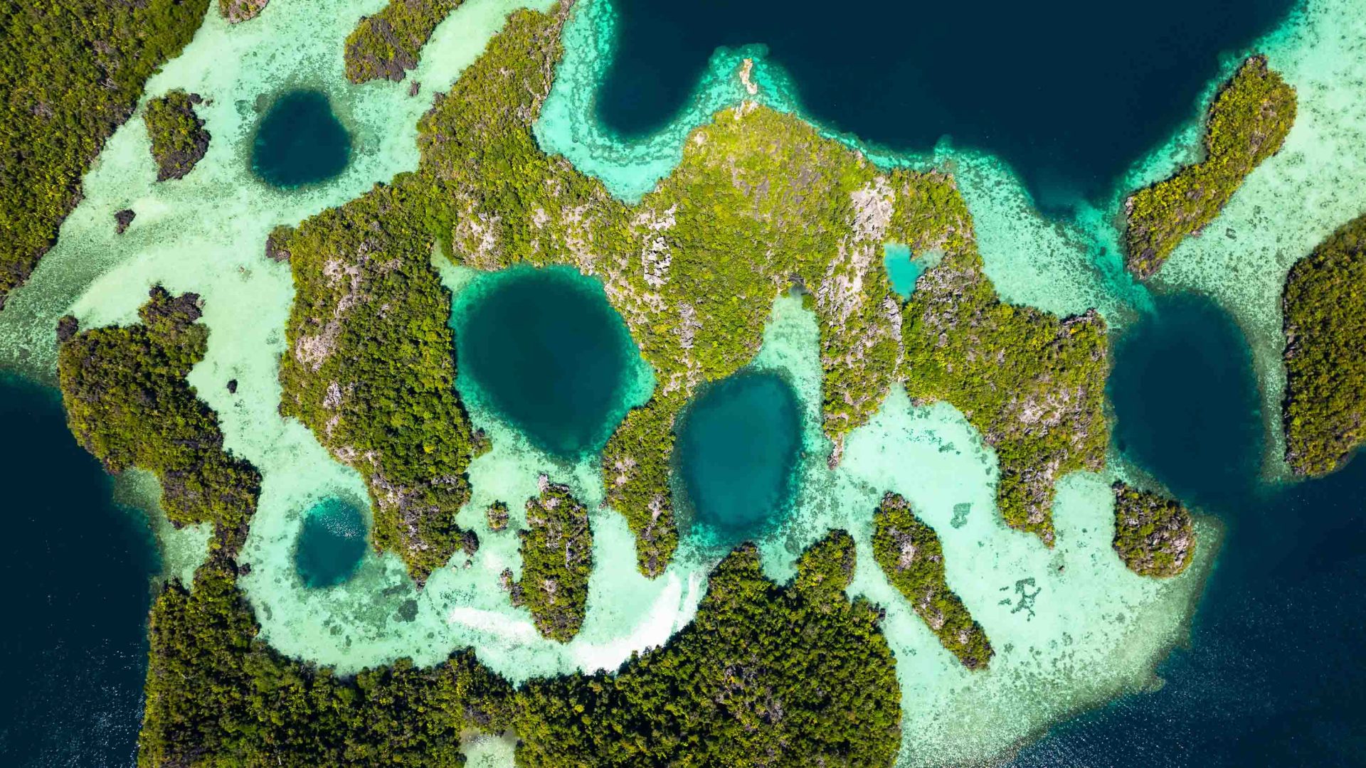 A drone shot of islands with lagoons between them.