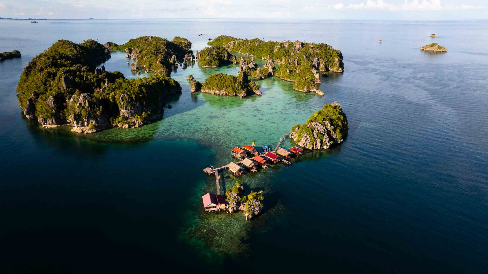 A drone shot of a homestay attached to the rocky outcrop of a small island.