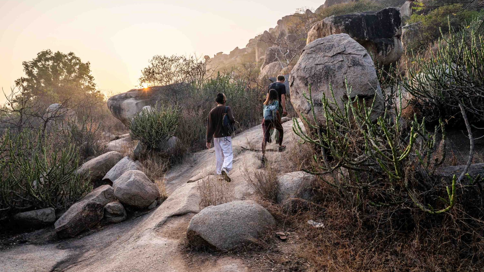 People climb up a rocky path.