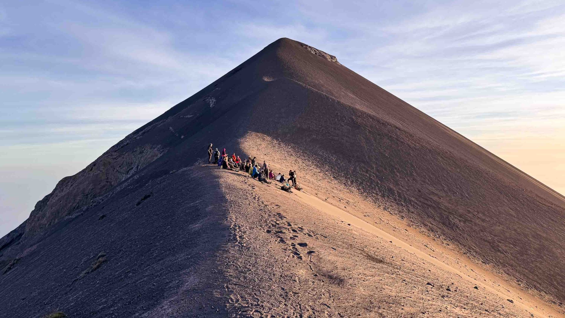 Travelers stop to rest near the summit of the volcano