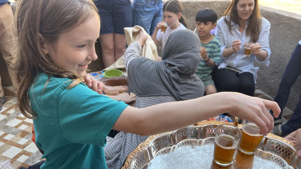 A young girl tries mint tea for the first time in Morocco