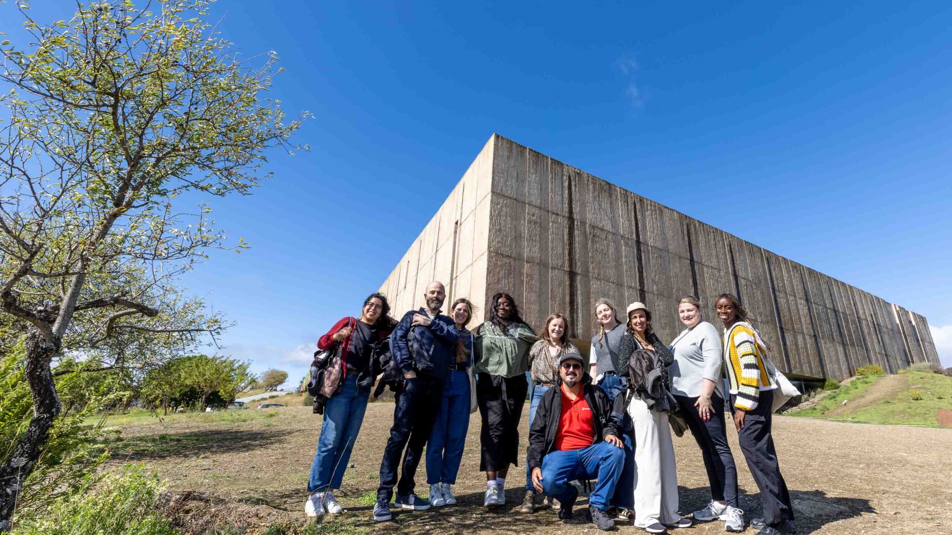 A group portrait in front of a museum.