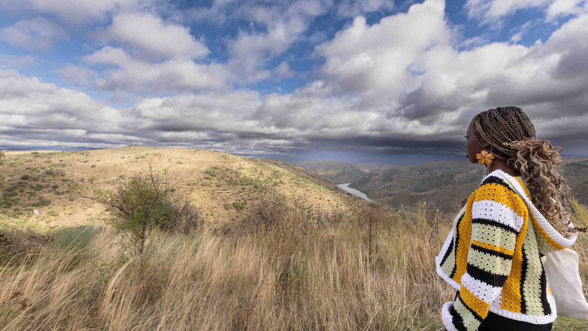 A woman looks out over a valley.