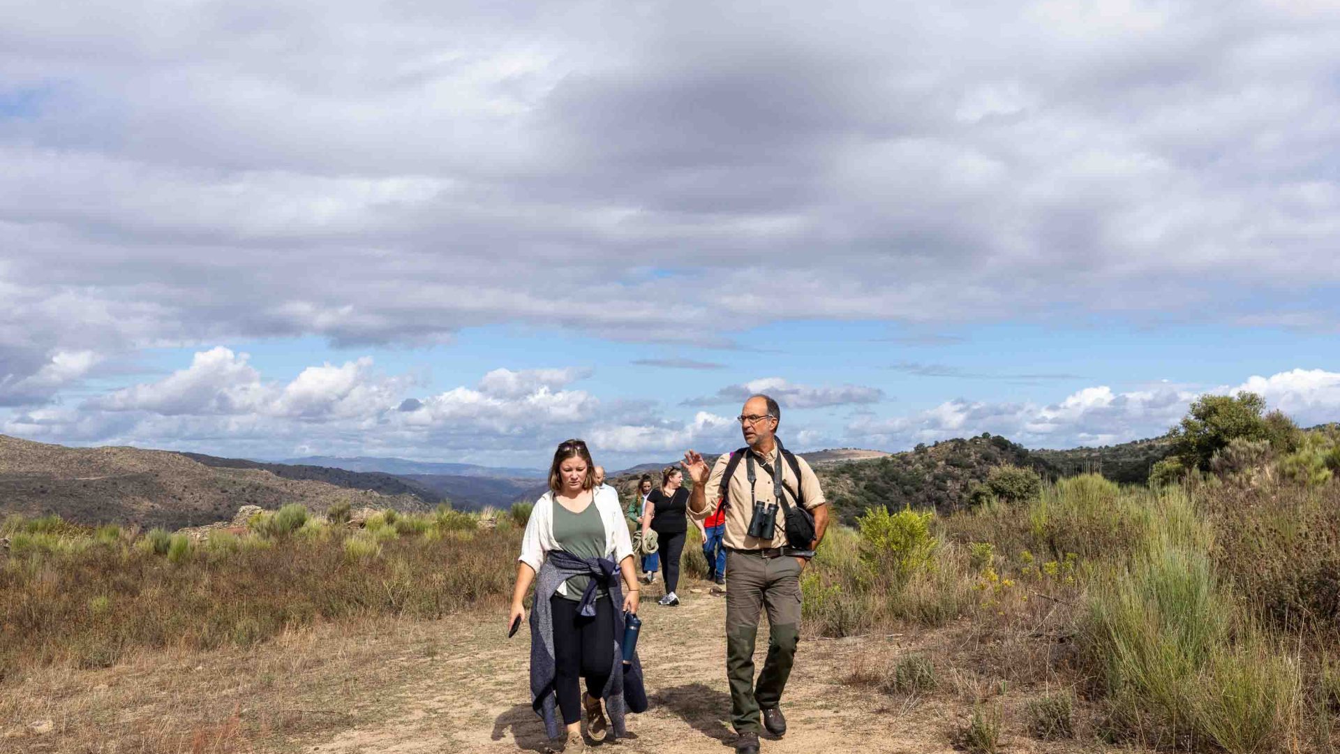 People ascend a hill.