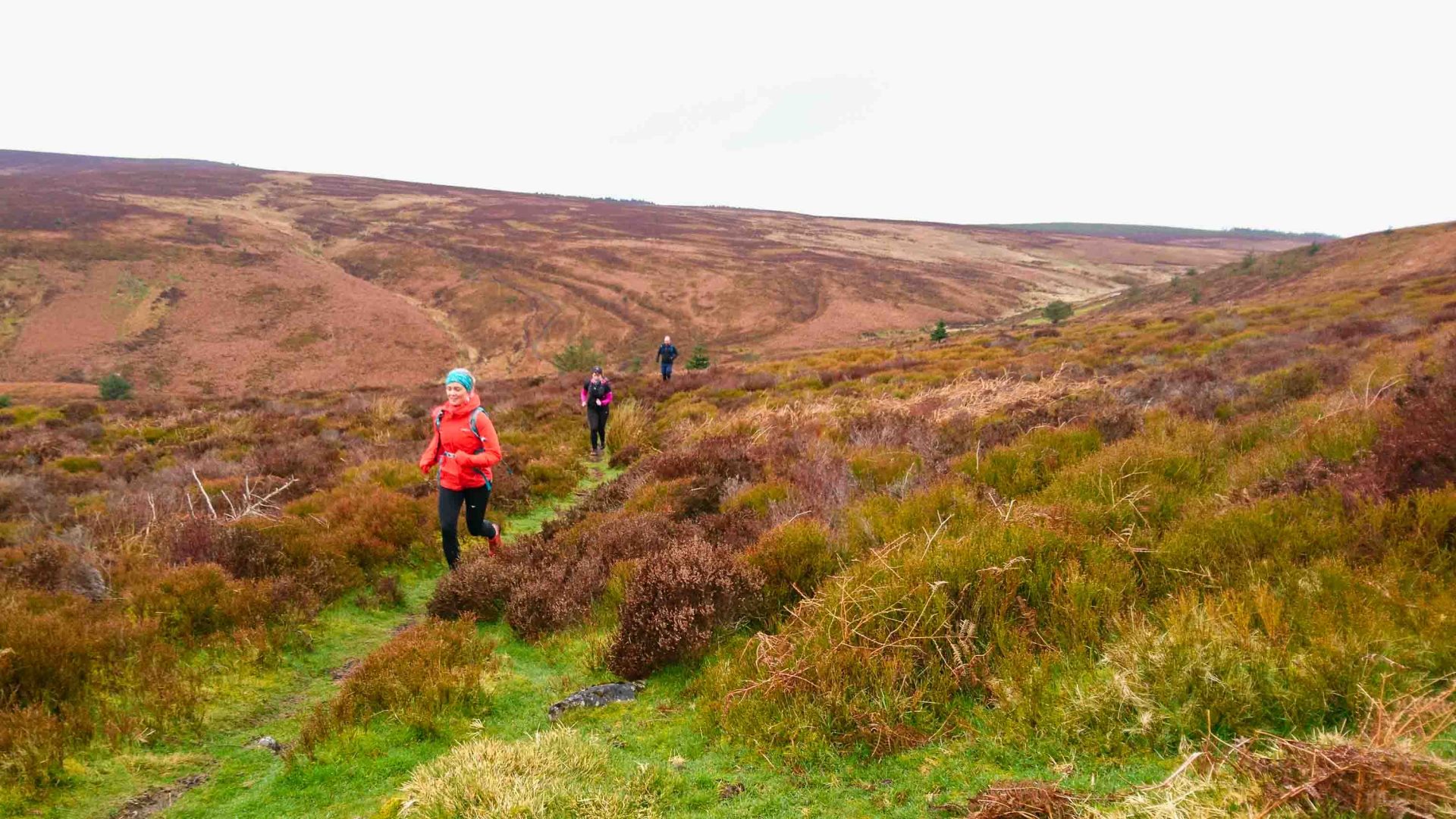 A group of women trail-running in the hills
